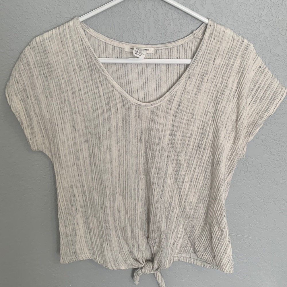 A cream/white with hints of gray blouse